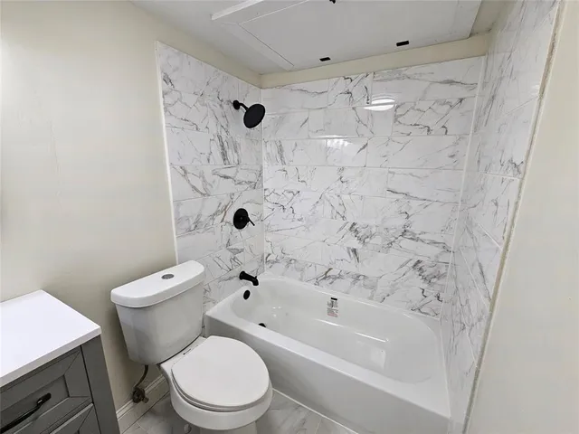 a white toilet sitting next to a bath tub shower