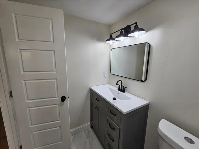 a bathroom with a sink toilet and tub