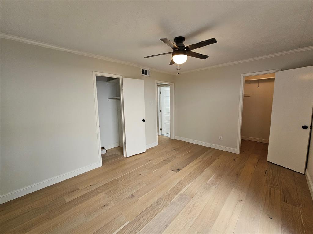 4327 Holland Avenue, Unit 102 Dallas, TX 75219 - Photo 17 of 20 a view of empty room with wooden floor and fan