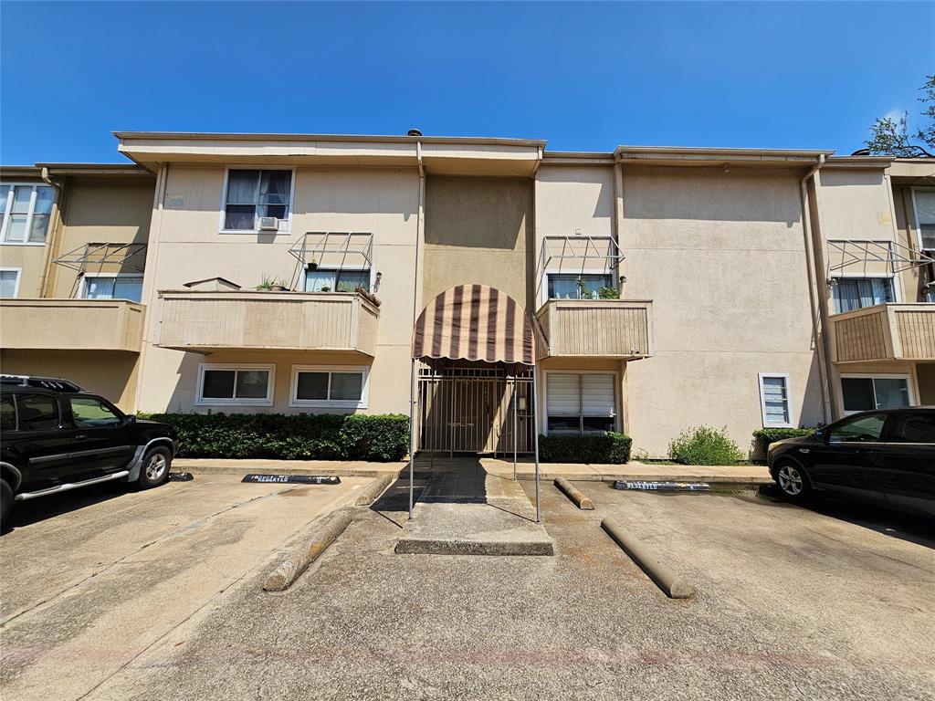 4327 Holland Avenue, Unit 102 Dallas, TX 75219 - Photo 20 of 20 a front view of a house with a yard