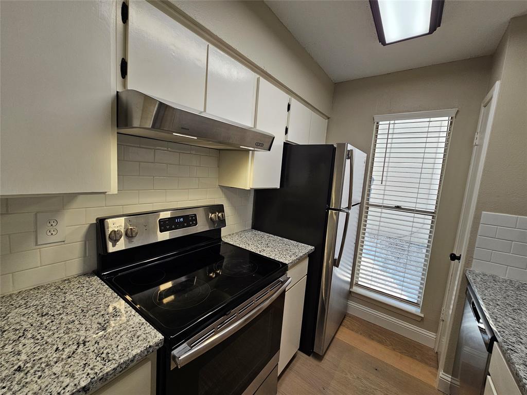4327 Holland Avenue, Unit 102 Dallas, TX 75219 - Photo 2 of 20 a kitchen with stainless steel appliances granite countertop a refrigerator and a stove