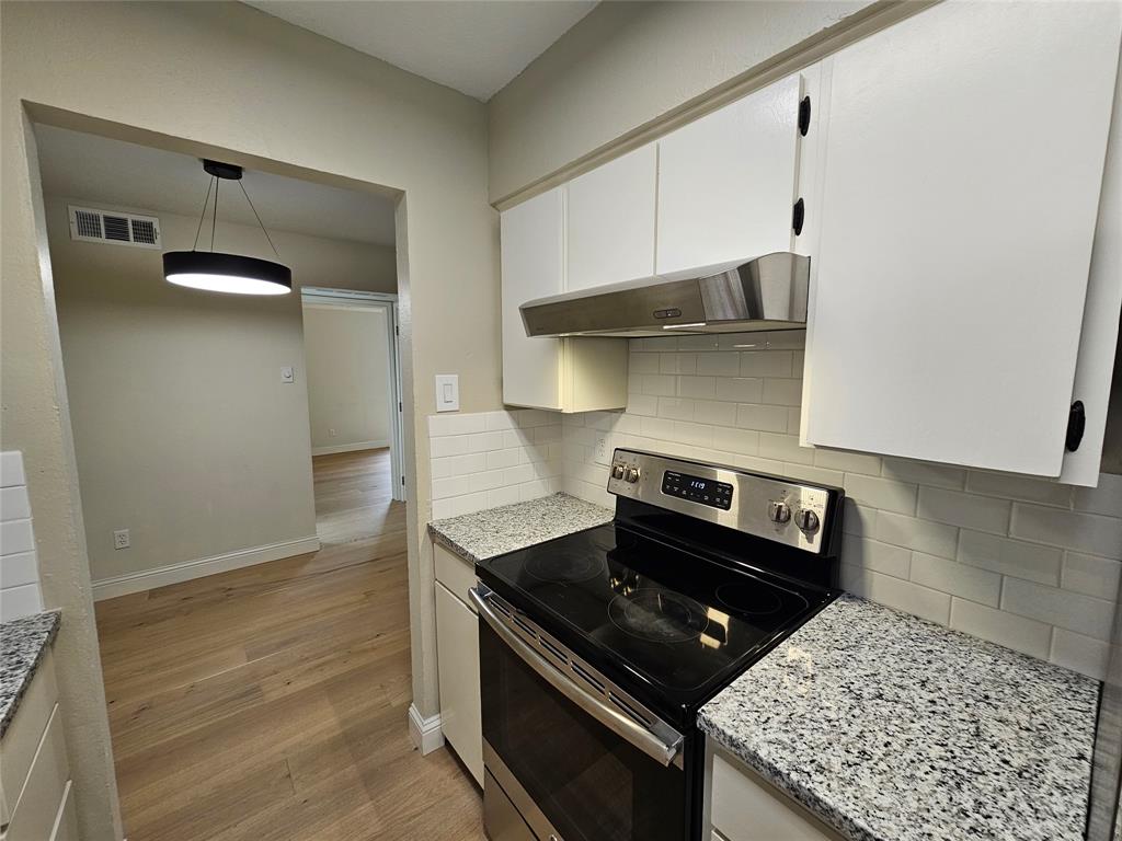 4327 Holland Avenue, Unit 102 Dallas, TX 75219 - Photo 4 of 20 a stove top oven sitting inside of a kitchen