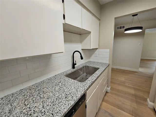 a kitchen with a sink and cabinets
