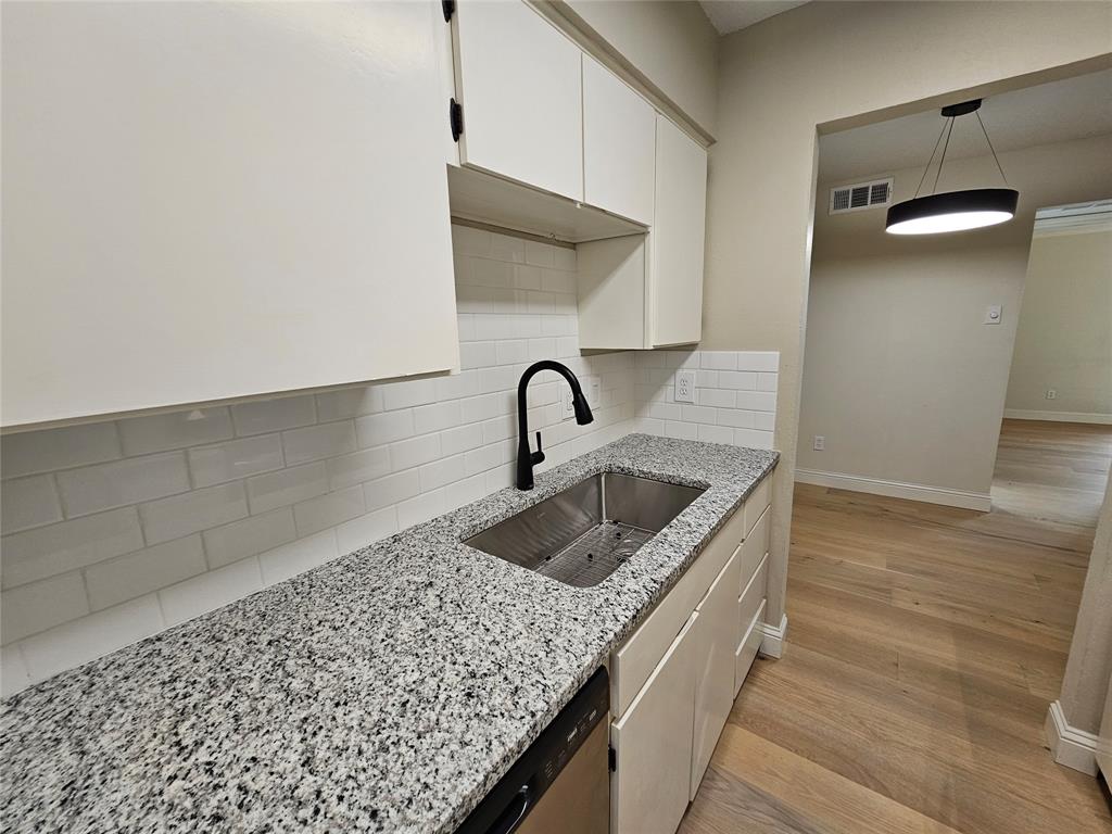 4327 Holland Avenue, Unit 102 Dallas, TX 75219 - Photo 5 of 20 a kitchen with a sink and cabinets