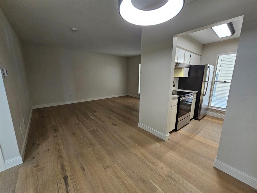 4327 Holland Avenue, Unit 102 Dallas, TX 75219 - Photo 7 of 20 a view of a livingroom with wooden floor