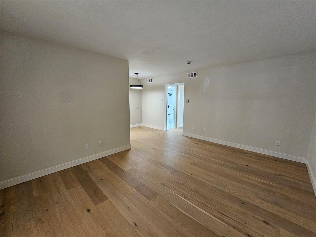 4327 Holland Avenue, Unit 102 Dallas, TX 75219 - Photo 9 of 20 a view of an empty room and wooden floor