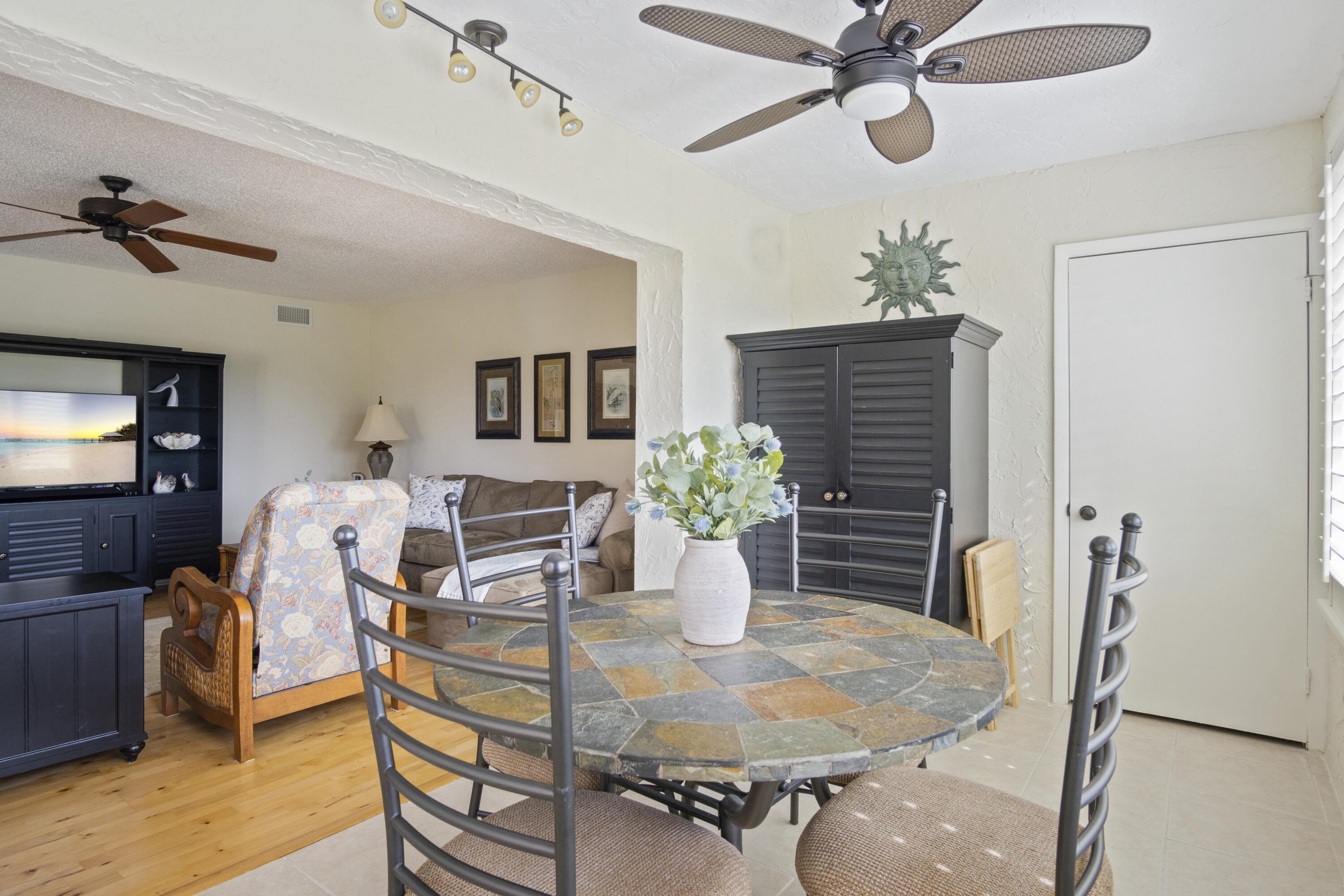 5335 Southeast Miles Grant Road, Unit H 209 Stuart, FL 34997 - Photo 12 of 26 a dining room with furniture and window