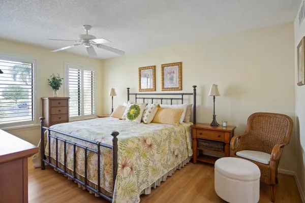 a bedroom with a bed a chandelier and a mirror