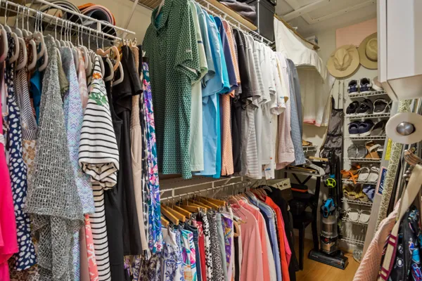 a view of walk in closet with clothes