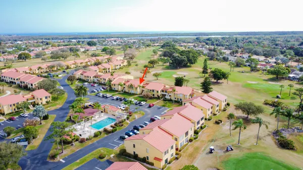 an aerial view of lake and residential houses with outdoor space