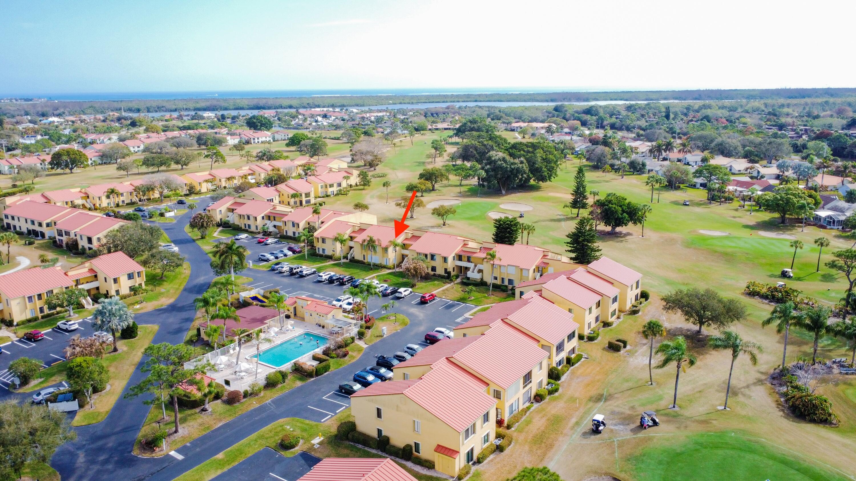 5335 Southeast Miles Grant Road, Unit H 209 Stuart, FL 34997 - Photo 24 of 26 an aerial view of lake and residential houses with outdoor space