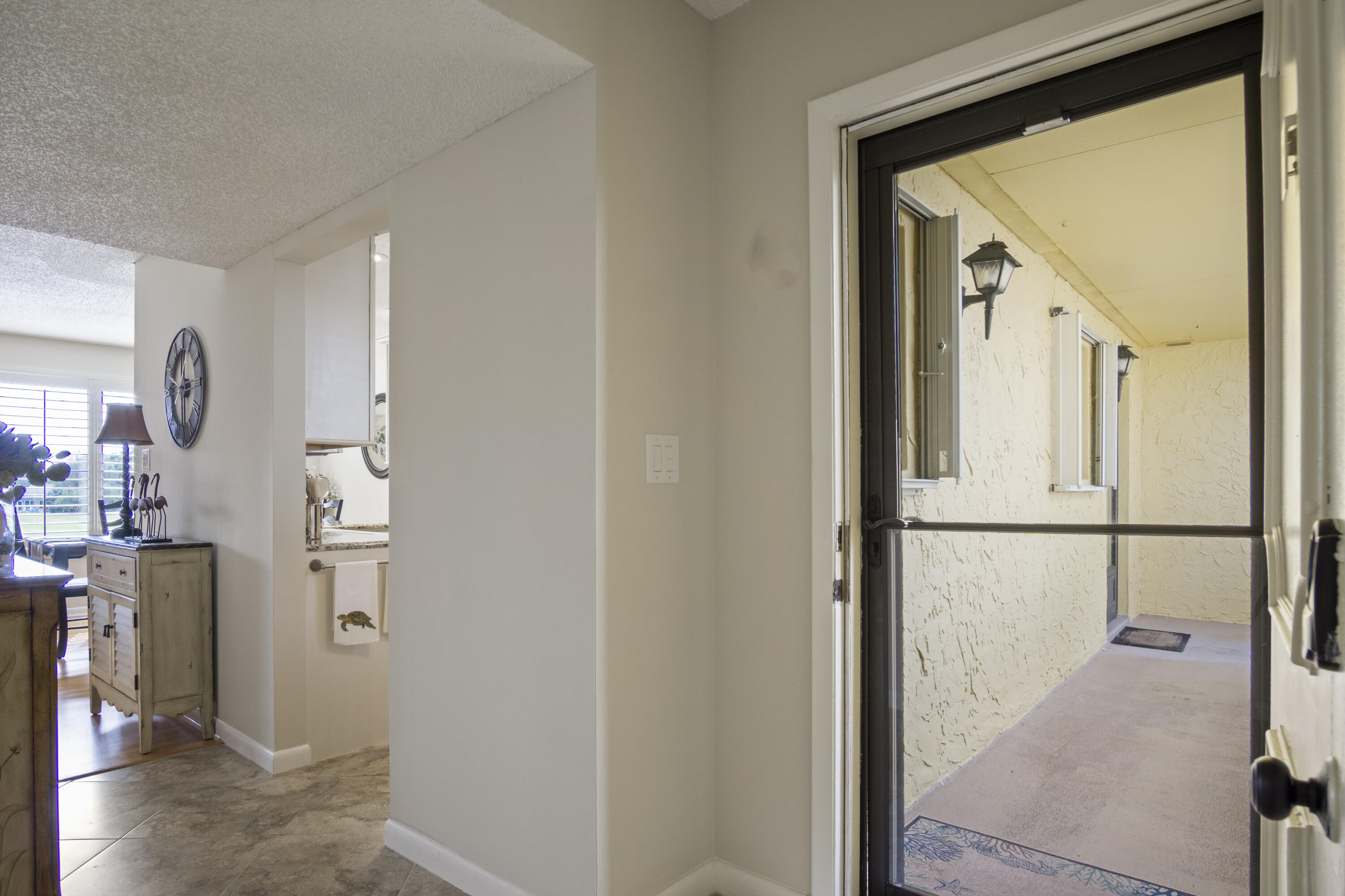 5335 Southeast Miles Grant Road, Unit H 209 Stuart, FL 34997 - Photo 26 of 26 a view of a hallway with kitchen and refrigerator