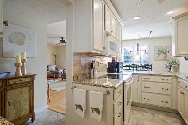 a kitchen with stainless steel appliances granite countertop a sink stove and cabinets