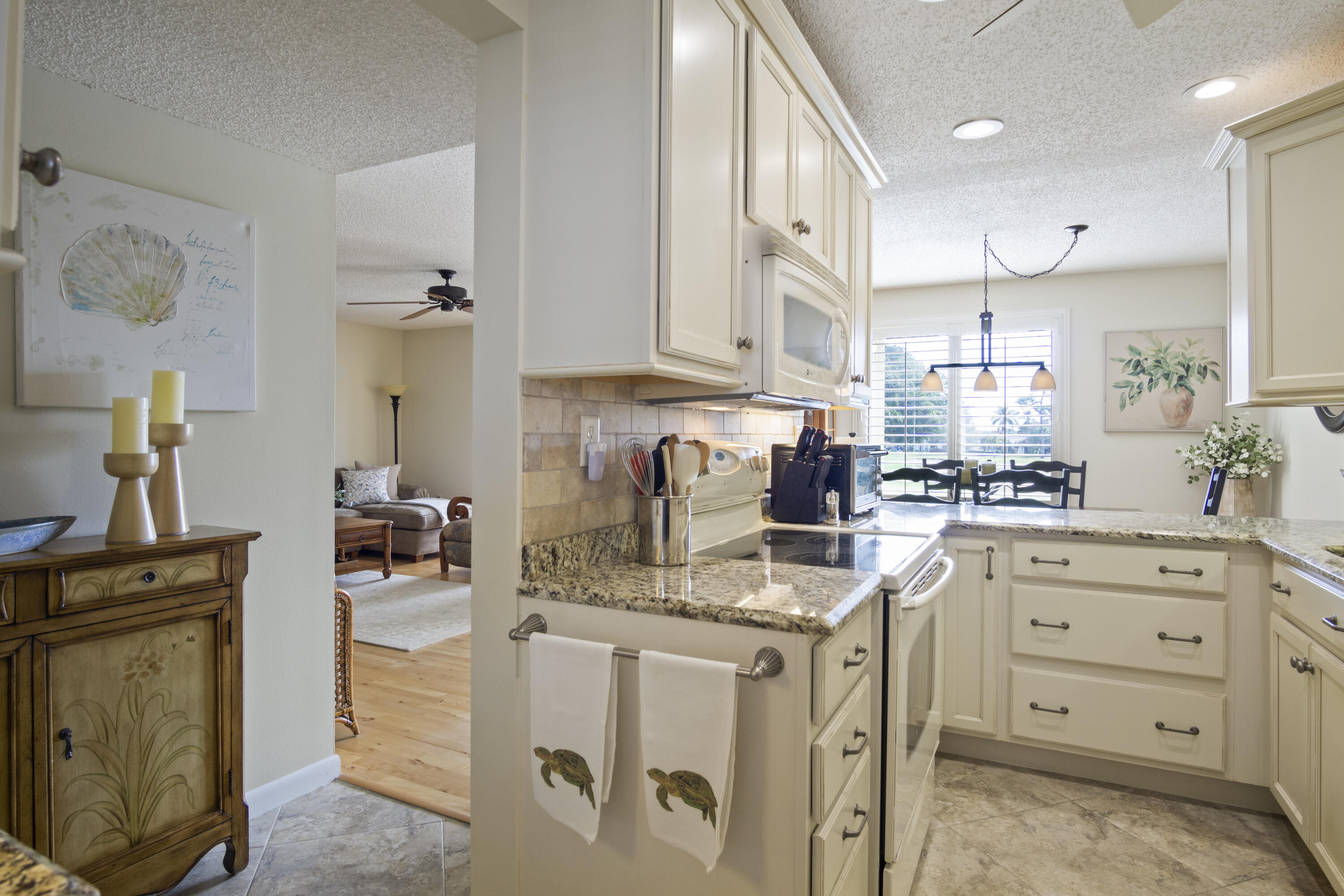 5335 Southeast Miles Grant Road, Unit H 209 Stuart, FL 34997 - Photo 5 of 26 a kitchen with stainless steel appliances granite countertop a sink stove and cabinets