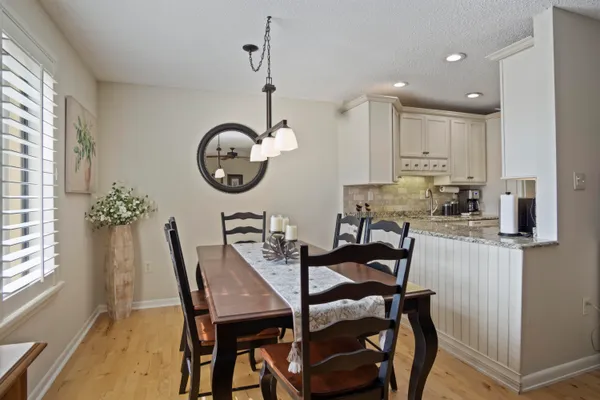 a view of a dining room with furniture and a chandelier