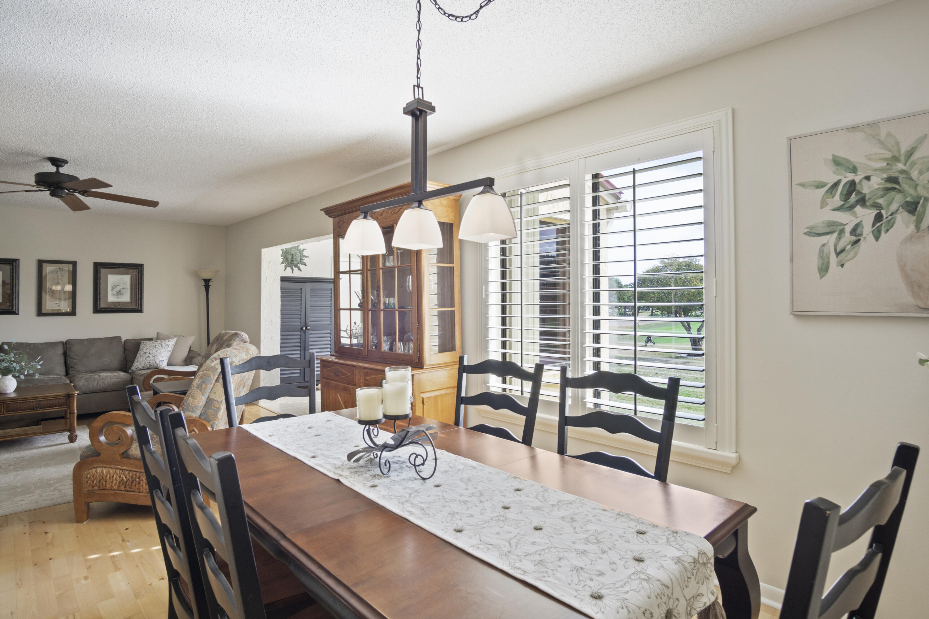 5335 Southeast Miles Grant Road, Unit H 209 Stuart, FL 34997 - Photo 7 of 26 a view of a dining room and livingroom with furniture wooden floor a chandelier