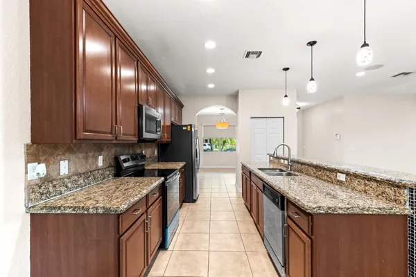 a kitchen with a stove and a wooden floor