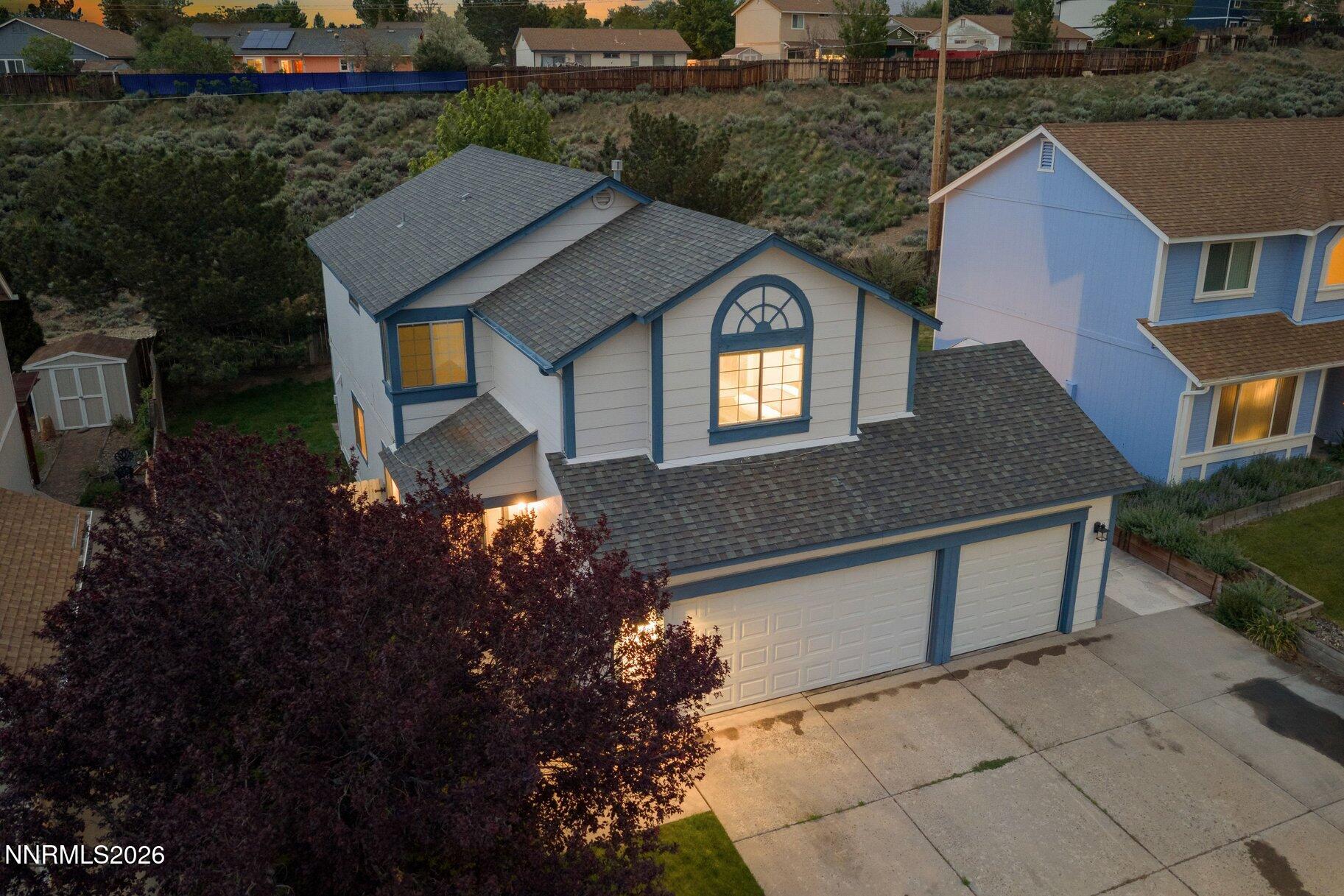 8486 Piper Place Reno, NV 89506 - Photo 74 of 80 a front view of a house with a yard and garage
