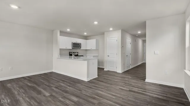 a view of a kitchen with wooden floor and a sink