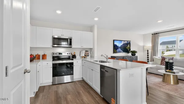 a kitchen with stainless steel appliances a sink stove and refrigerator