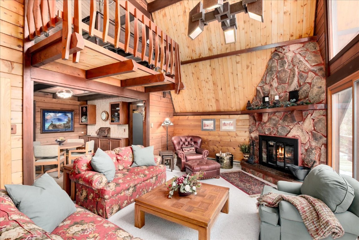 522 Wellington Road Breckenridge, CO 80424 - Photo 11 of 43 a living room with furniture a fireplace and a floor to ceiling window