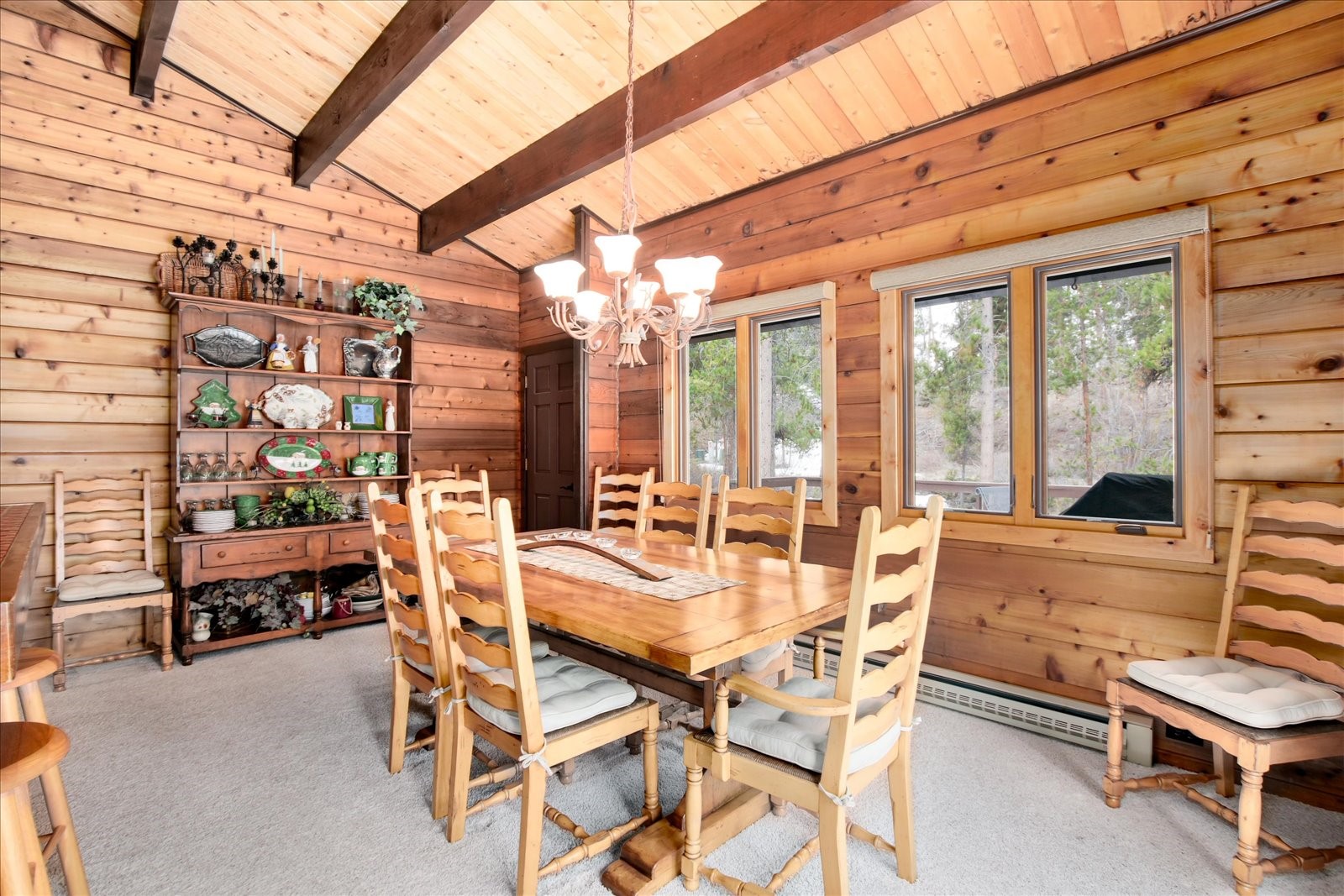522 Wellington Road Breckenridge, CO 80424 - Photo 18 of 43 a dining room with furniture and a floor to ceiling window