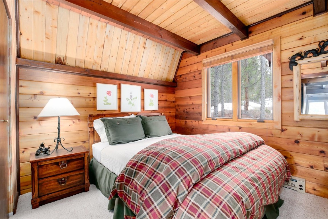 522 Wellington Road Breckenridge, CO 80424 - Photo 23 of 43 a bedroom with a bed and a lamp on the dresser