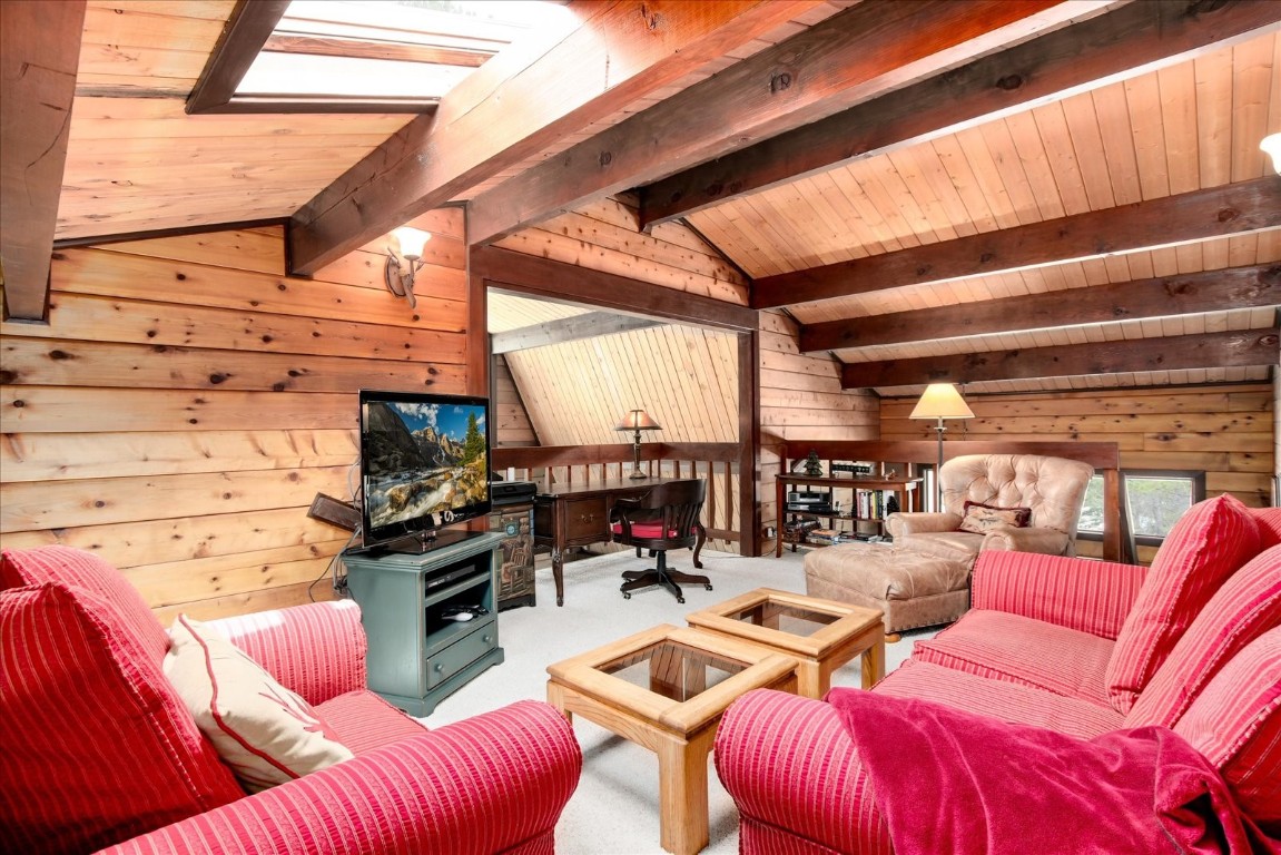 522 Wellington Road Breckenridge, CO 80424 - Photo 30 of 43 a living room with furniture a fireplace and a table