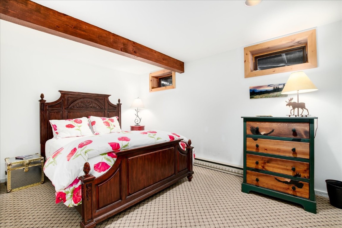 522 Wellington Road Breckenridge, CO 80424 - Photo 34 of 43 a bedroom with a bed and a dresser
