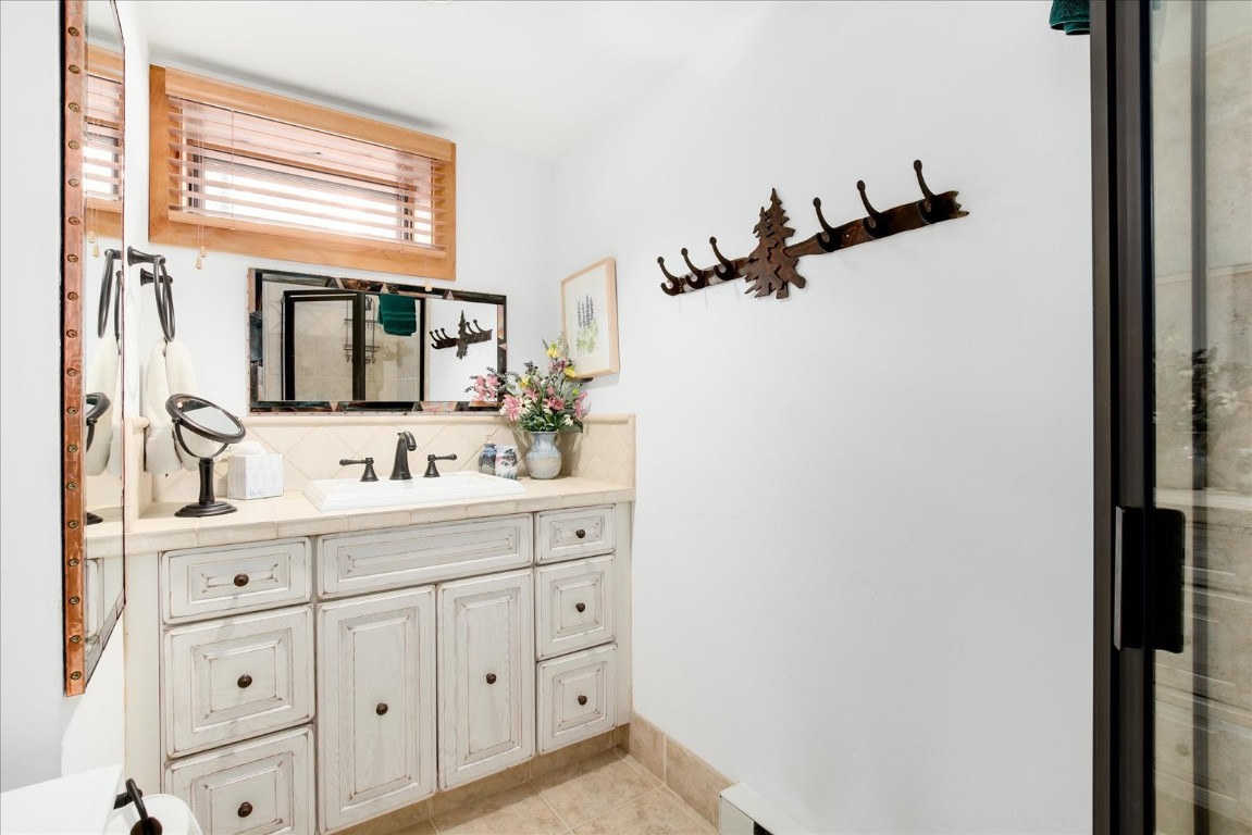 522 Wellington Road Breckenridge, CO 80424 - Photo 35 of 43 a bathroom with a sink and mirror