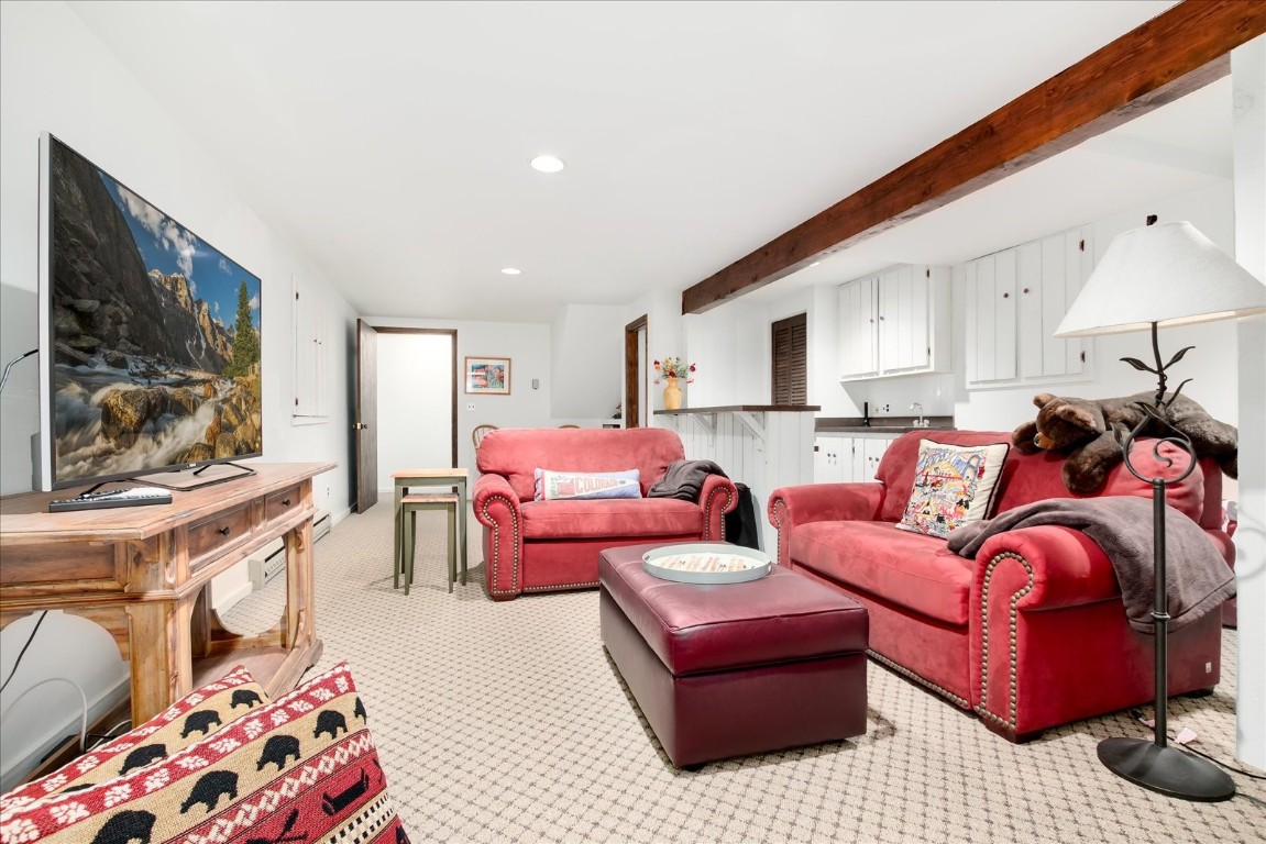 522 Wellington Road Breckenridge, CO 80424 - Photo 37 of 43 a living room with furniture and a flat screen tv