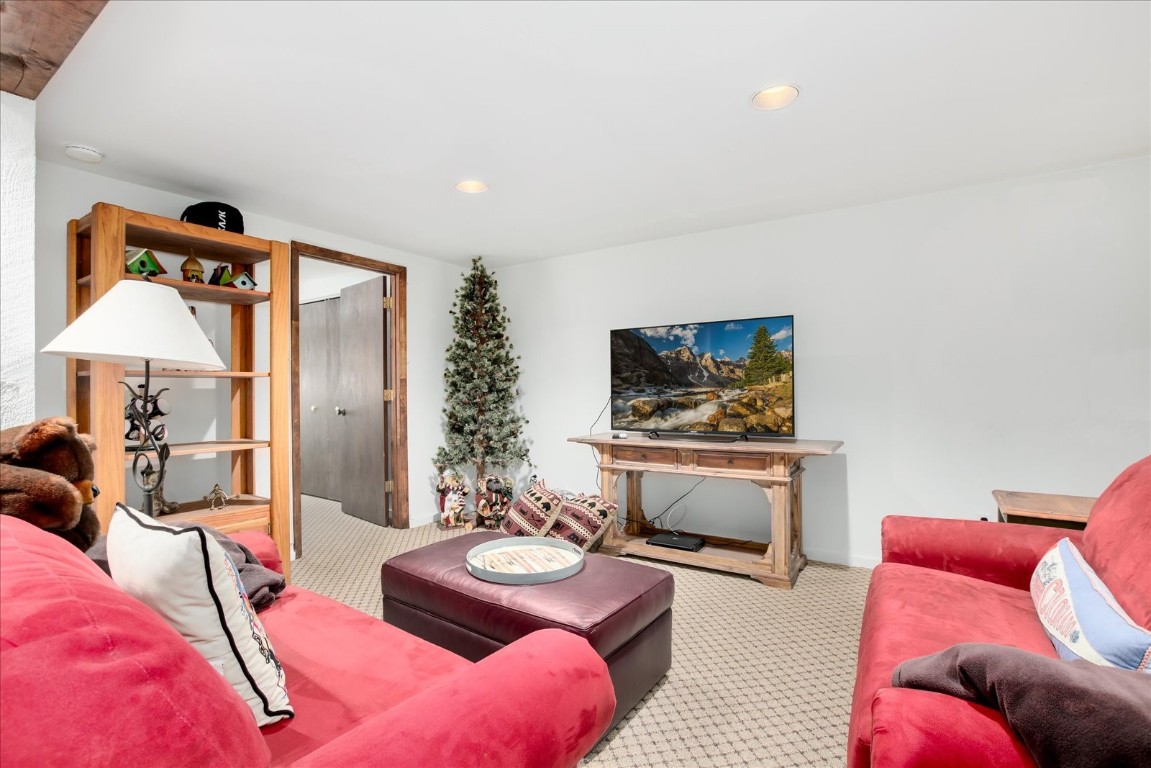 522 Wellington Road Breckenridge, CO 80424 - Photo 38 of 43 a living room with furniture and a flat screen tv