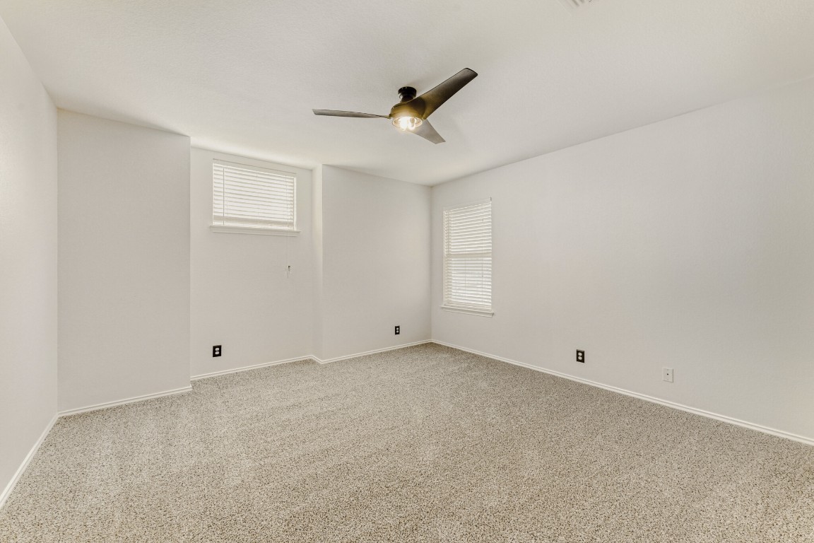 4010 Reeders Drive Austin, TX 78725 - Photo 20 of 26 Empty room featuring light carpet and ceiling fan