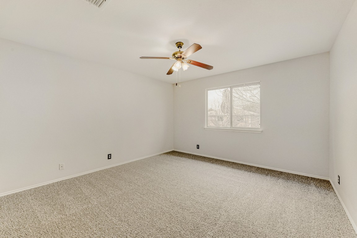 4010 Reeders Drive Austin, TX 78725 - Photo 21 of 26 Empty room featuring light carpet and ceiling fan
