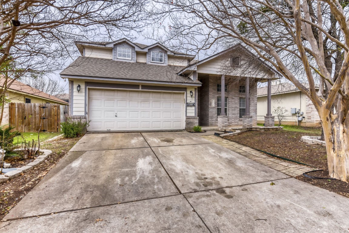 4010 Reeders Drive Austin, TX 78725 - Photo 3 of 26 Traditional-style house with concrete driveway, a shingled roof, covered porch, a garage, and brick siding