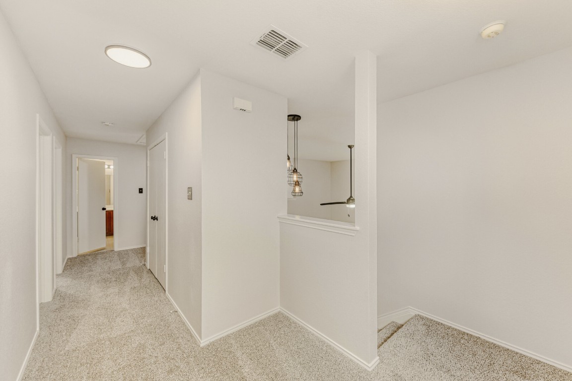 4010 Reeders Drive Austin, TX 78725 - Photo 5 of 26 Corridor featuring light carpet and baseboards
