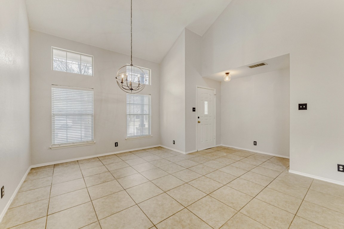 4010 Reeders Drive Austin, TX 78725 - Photo 10 of 26 Entrance foyer featuring high vaulted ceiling, light tile patterned flooring, and a chandelier