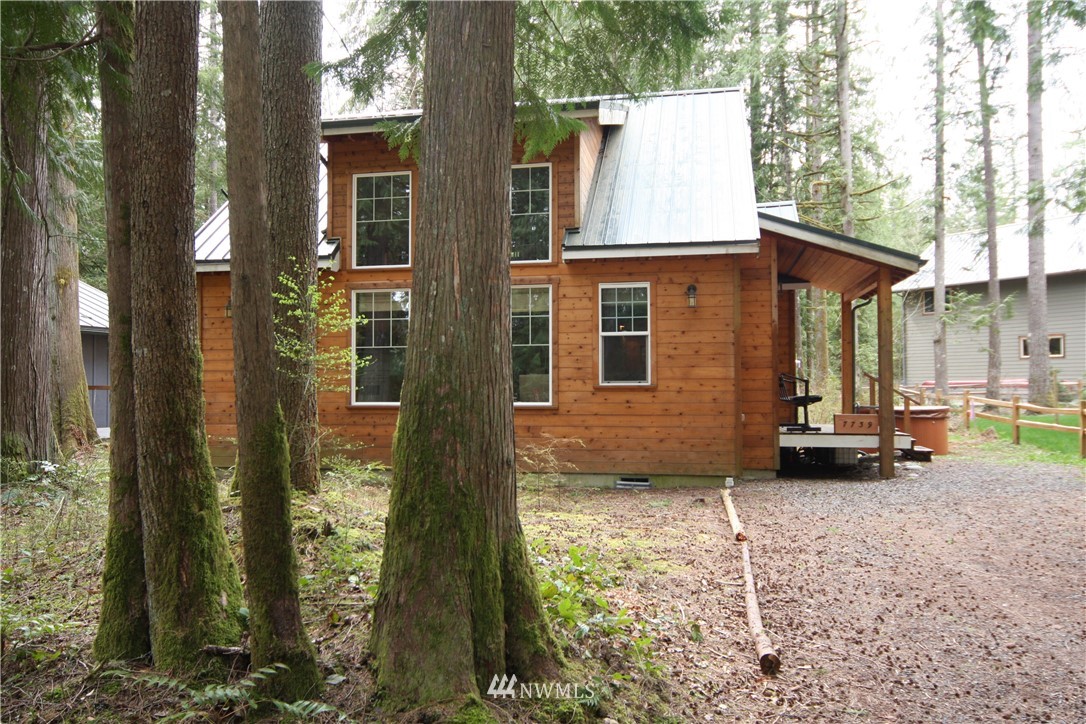 7739 View Ridge Drive Maple Falls, WA 98266 - Photo 2 of 15 a backyard of a house with yard and outdoor seating