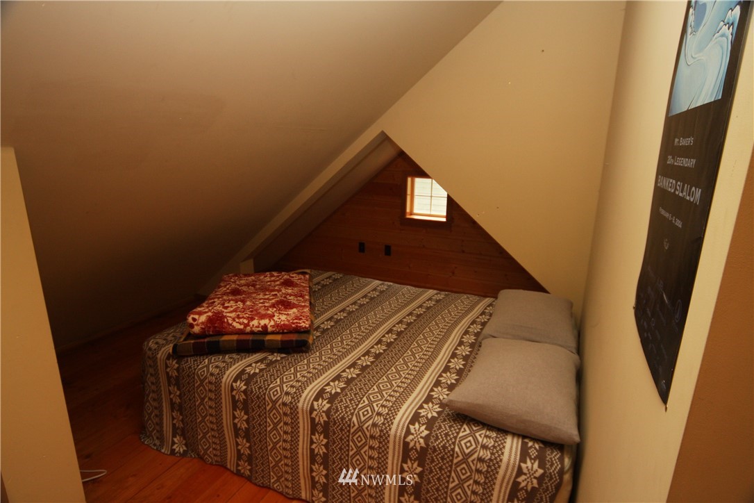 7739 View Ridge Drive Maple Falls, WA 98266 - Photo 12 of 15 a bed sitting in a bedroom next to a window
