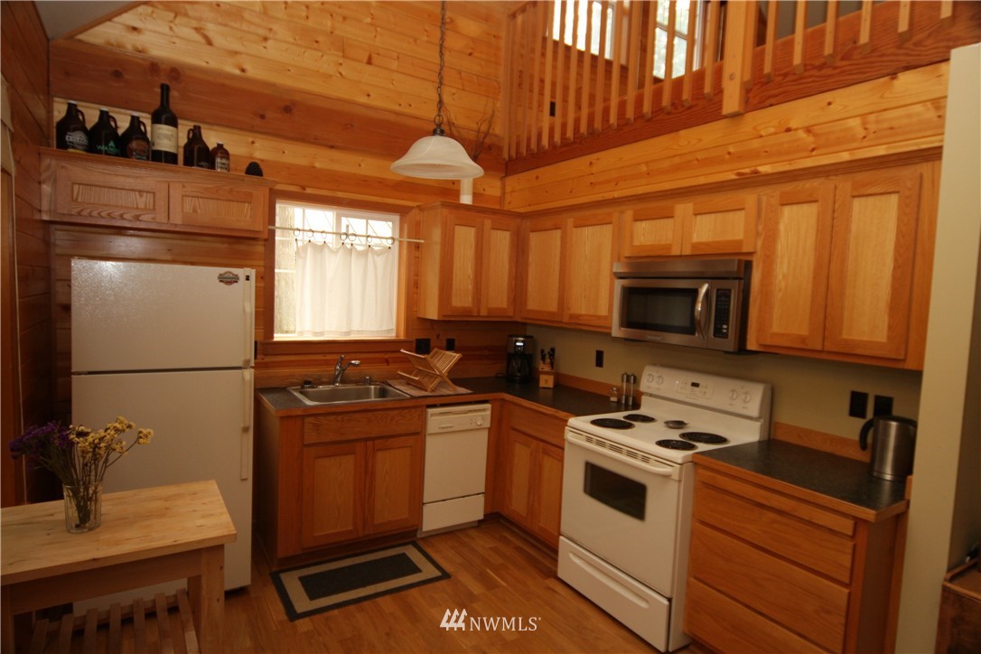 7739 View Ridge Drive Maple Falls, WA 98266 - Photo 4 of 15 a kitchen with stainless steel appliances a stove a sink and a refrigerator