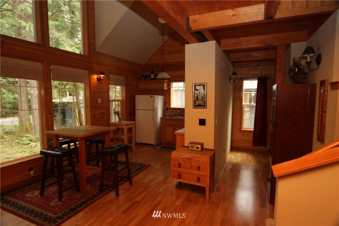 7739 View Ridge Drive Maple Falls, WA 98266 - Photo 6 of 15 a dining room with wooden floor a glass table and chairs