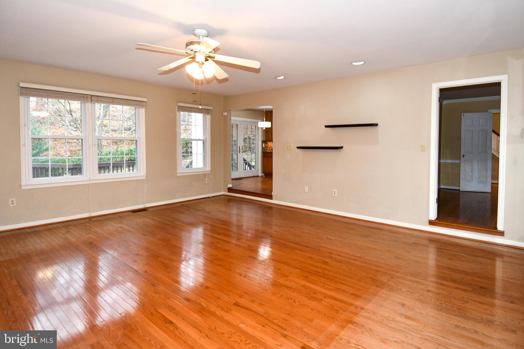 13135 Hutchinson Way Silver Spring, MD 20906 - Photo 11 of 64 a view of an empty room with wooden floor and a window