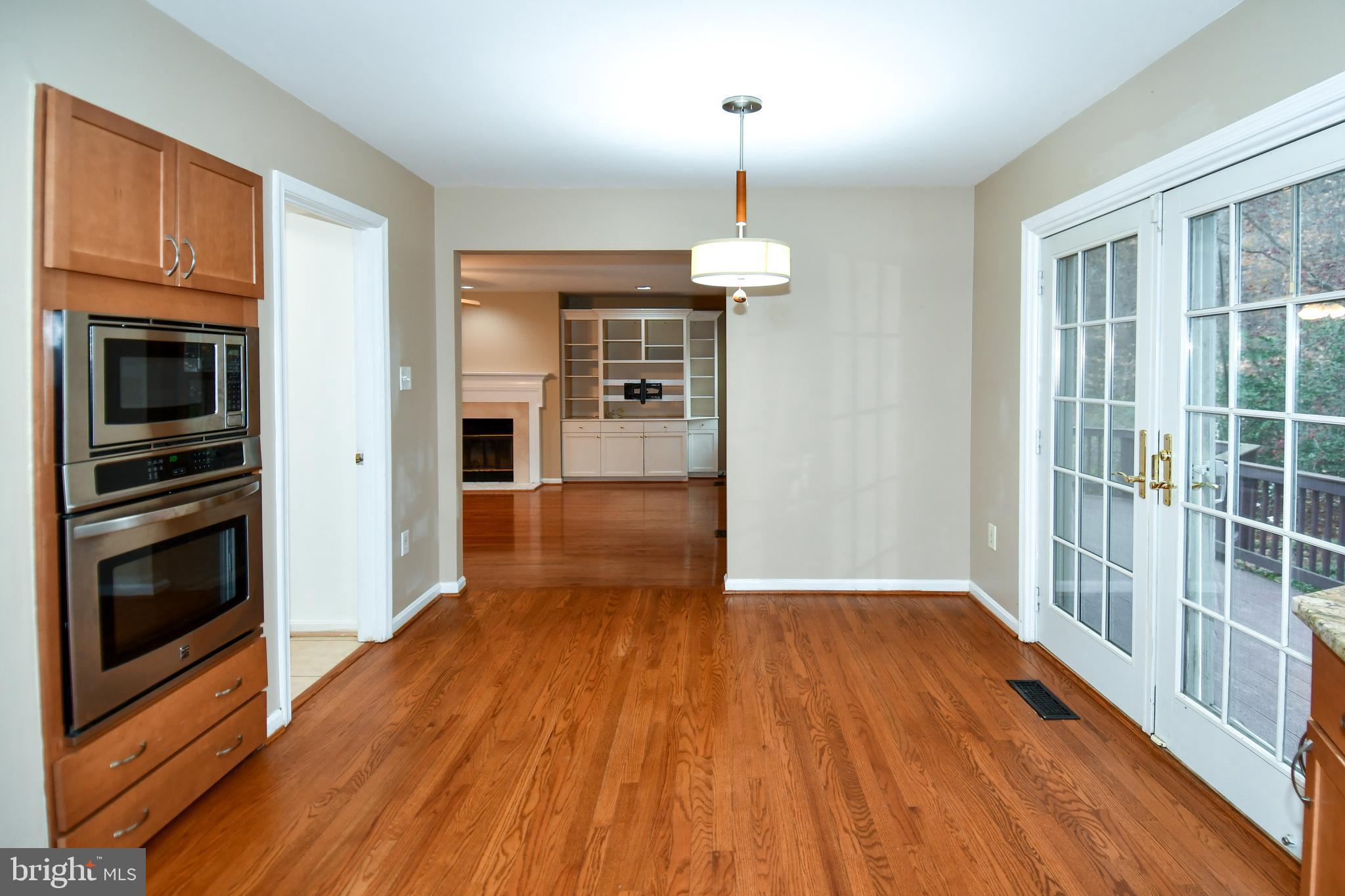 13135 Hutchinson Way Silver Spring, MD 20906 - Photo 12 of 64 a view of empty room with wooden floor fireplace and windows