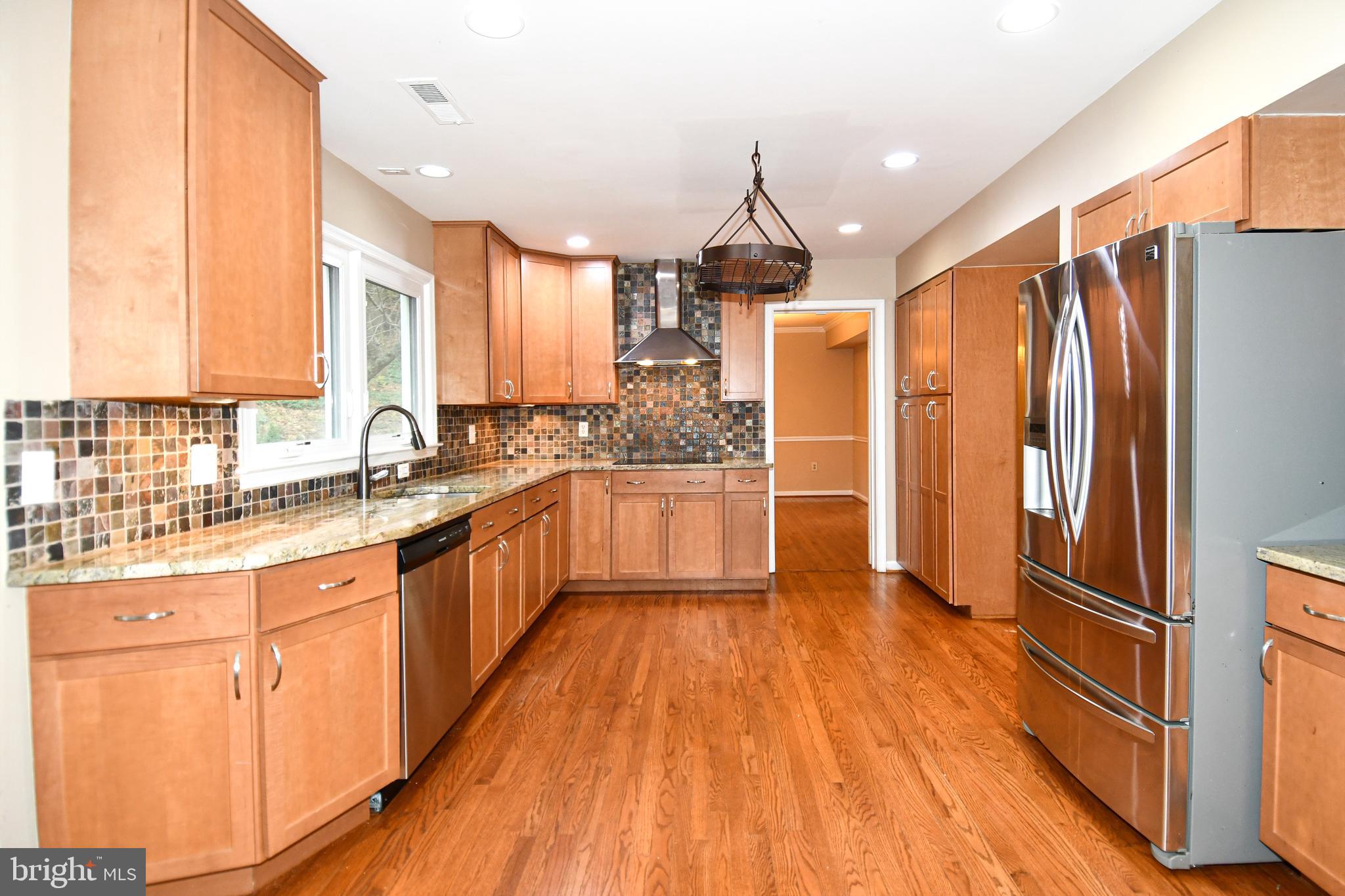 13135 Hutchinson Way Silver Spring, MD 20906 - Photo 20 of 64 a kitchen with stainless steel appliances a refrigerator sink and wooden floor