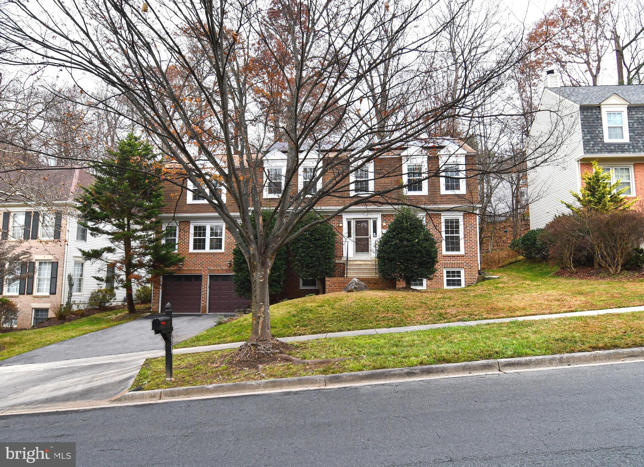 13135 Hutchinson Way Silver Spring, MD 20906 - Photo 2 of 64 a view of a house with a yard and large trees