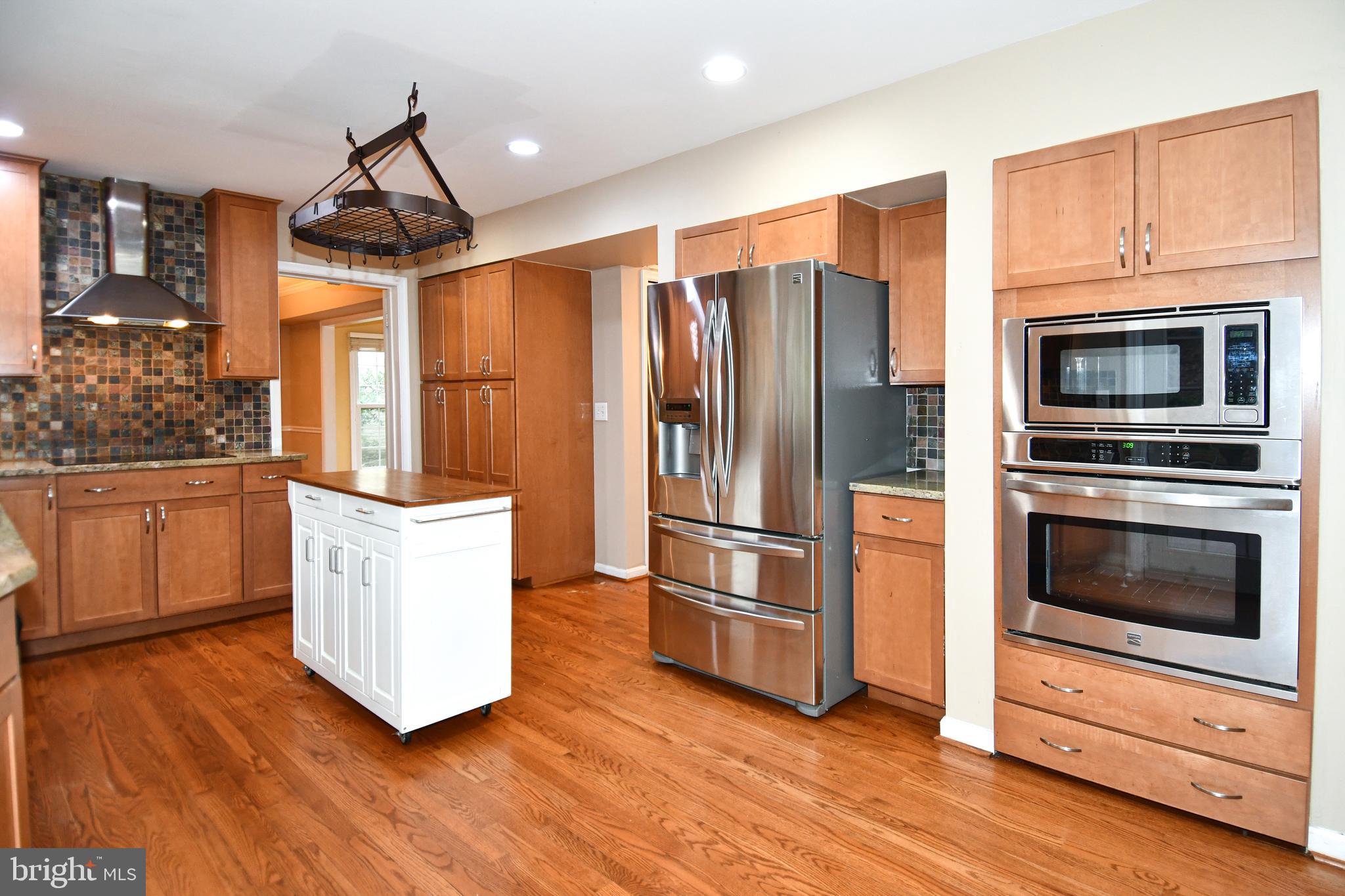 13135 Hutchinson Way Silver Spring, MD 20906 - Photo 22 of 64 a kitchen with stainless steel appliances a refrigerator stove and microwave