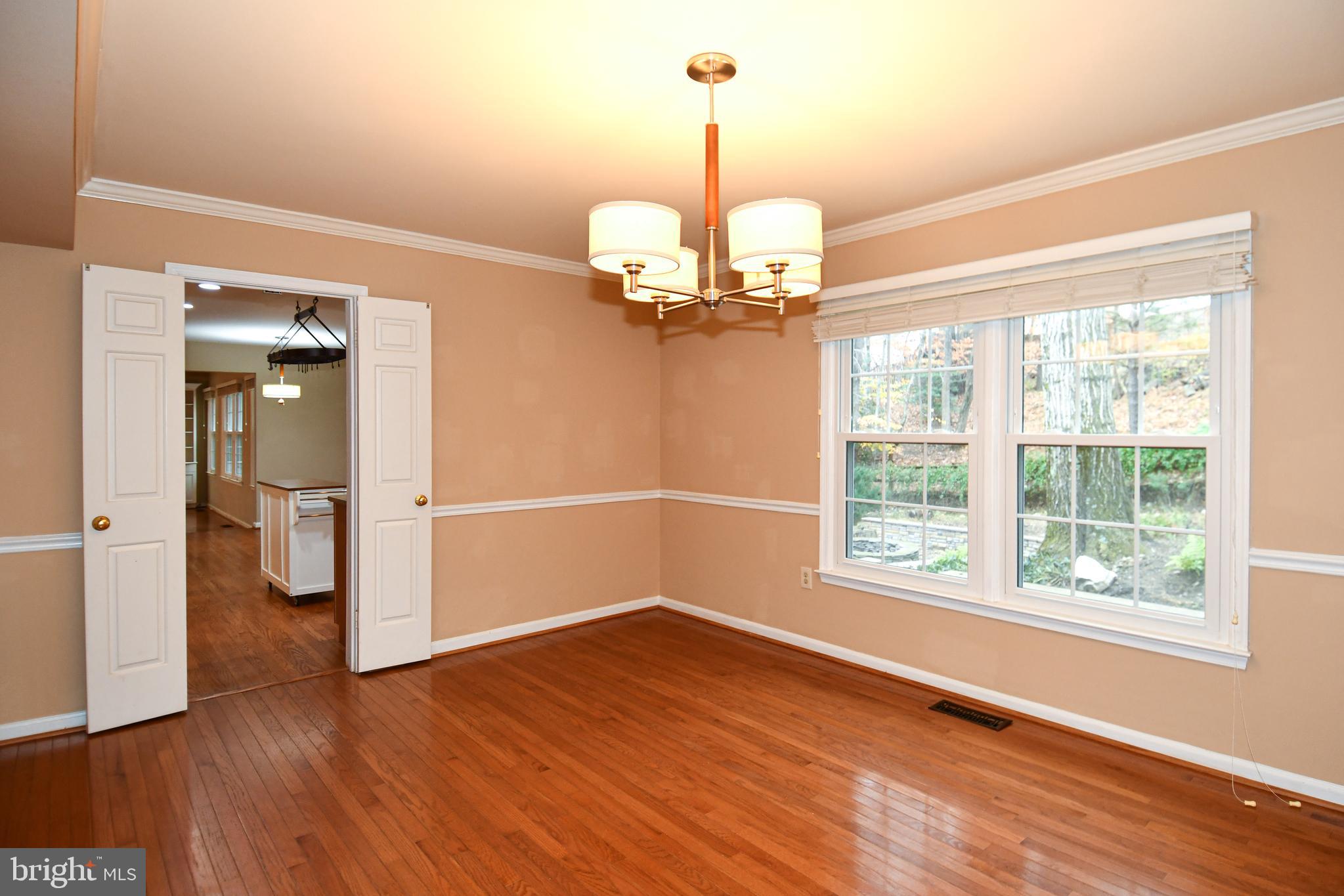 13135 Hutchinson Way Silver Spring, MD 20906 - Photo 23 of 64 a view of a room with wooden floor chandelier and windows