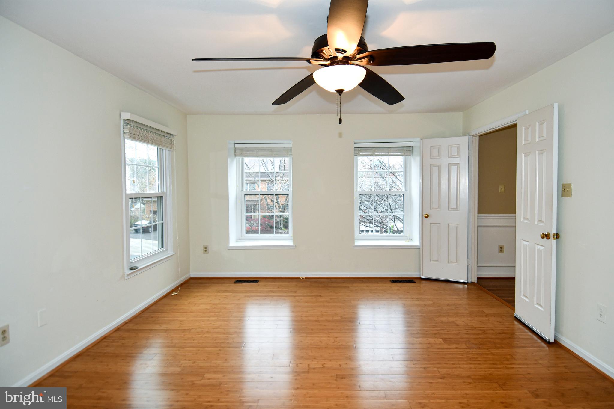 13135 Hutchinson Way Silver Spring, MD 20906 - Photo 33 of 64 a view of an empty room with wooden floor and a window