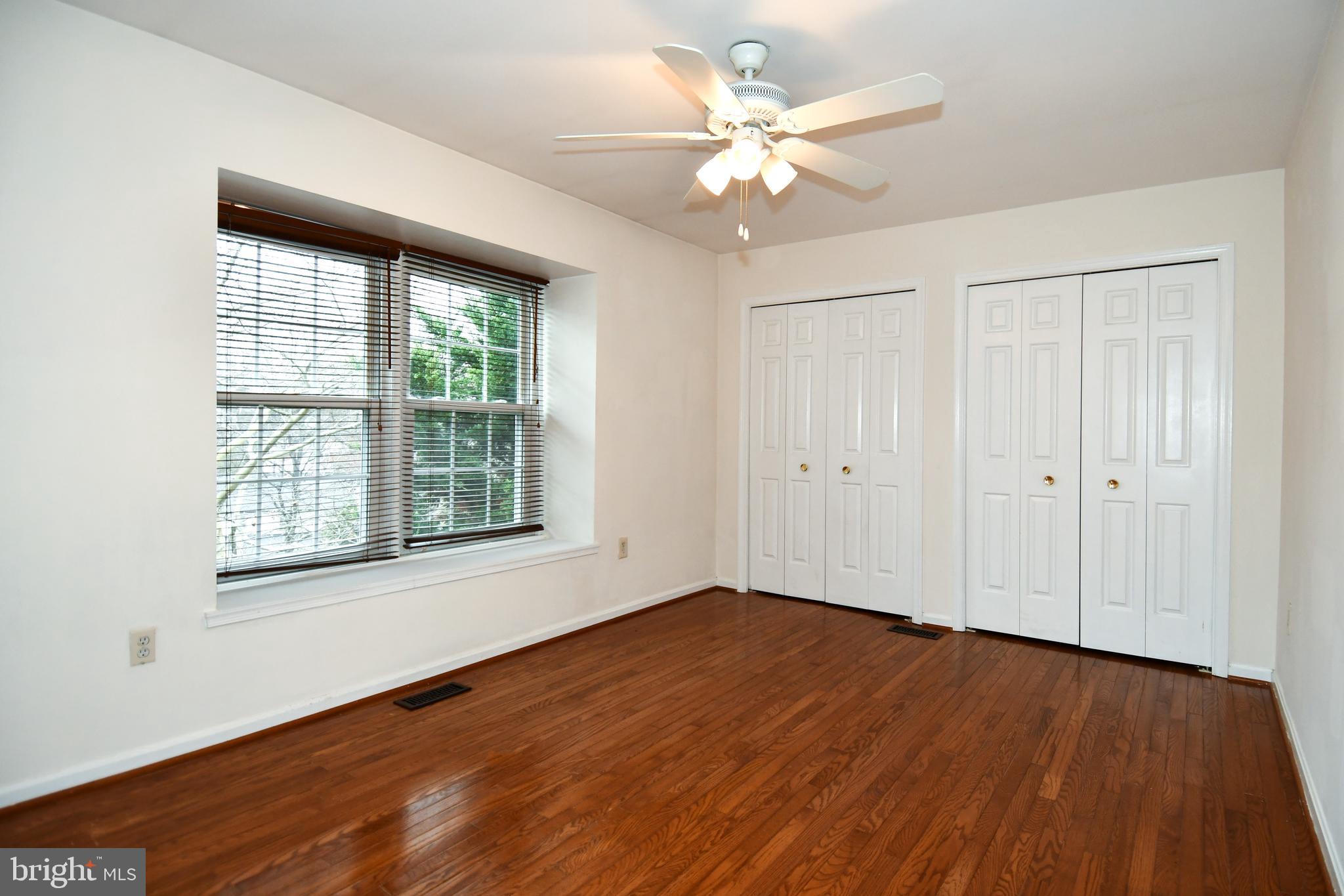 13135 Hutchinson Way Silver Spring, MD 20906 - Photo 43 of 64 a view of an empty room with wooden floor and a window