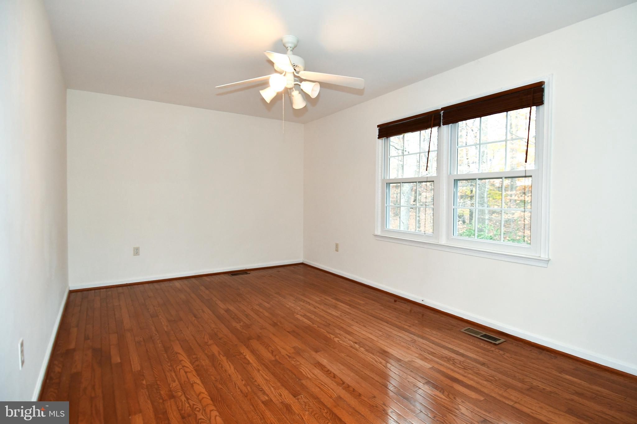 13135 Hutchinson Way Silver Spring, MD 20906 - Photo 44 of 64 a view of an empty room with wooden floor and a window